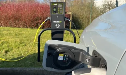 Blog Thumbnail Wide EV Car plugged in at EV Charging point at workplace