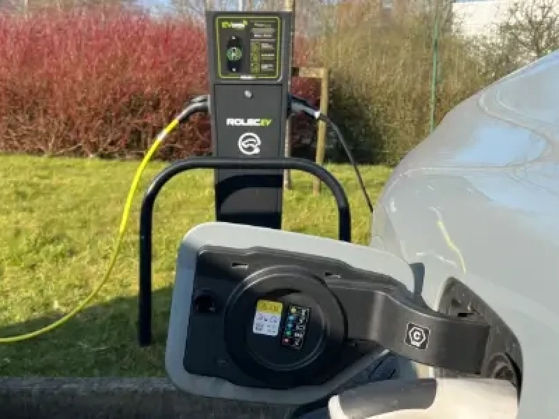 Blog Thumbnail Wide EV Car plugged in at EV Charging point at workplace